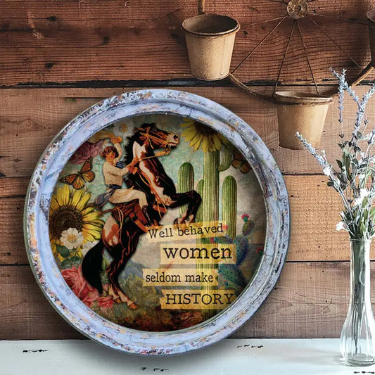 Western wall art with a horse and rider design and text on a wooden surface.