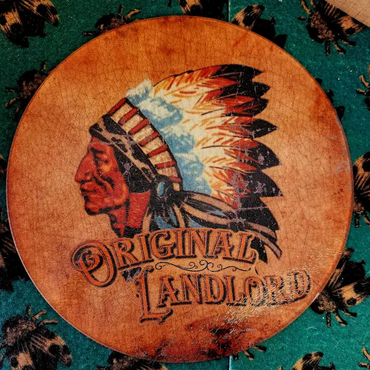 Glass cutting board with Native American chief design and 'Original Landlord' text on a textured background. - quirky home decor