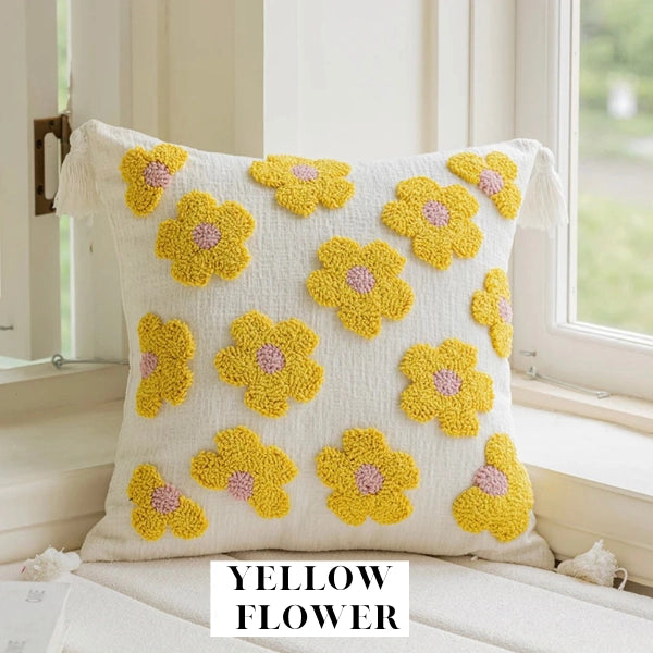 Decorative pillow with yellow flower patterns on a white background