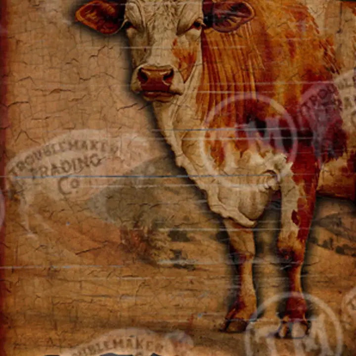 Western wall art depicting a cow on a textured background with vintage-style text.