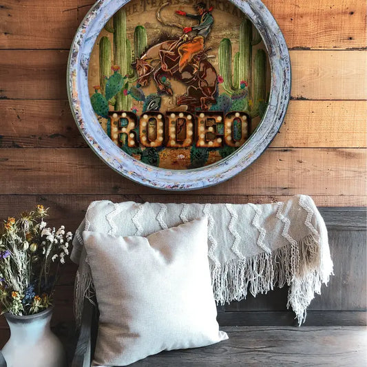 Decorative western wall decor with 'Rodeo' text and cowboy design on a wooden wall above a couch.