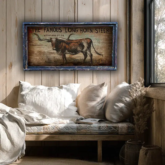 Decorative longhorn steer farmhouse wall decor on a wooden wall above a cozy sitting area.