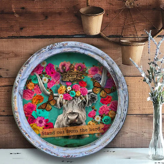 Decorative western wall art with a bull surrounded by flowers and butterflies on a wooden background.