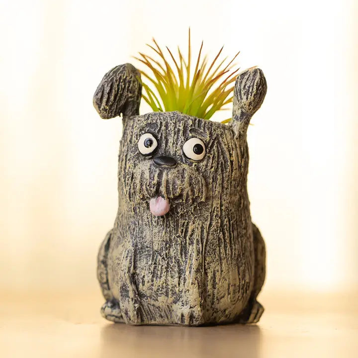 Cute dog-shaped planter with a plant on a blurred background
