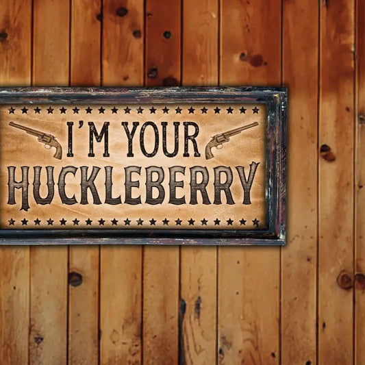 Vintage western art with 'I'm your Huckleberry' text and gun graphics on a wooden background