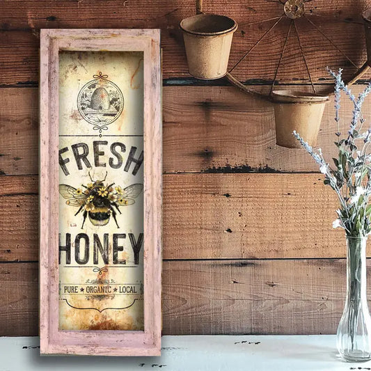 farmhouse wall art  'Fresh Honey' sign with a bee design on a wooden wall.