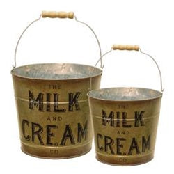 Two vintage-style metal buckets with 'The Milk and Cream Co' text on a white background