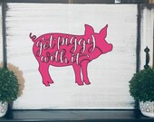 A pink pig-stove cover with the words 'Get Piggy With It in white script, Pink Platypus Emporium