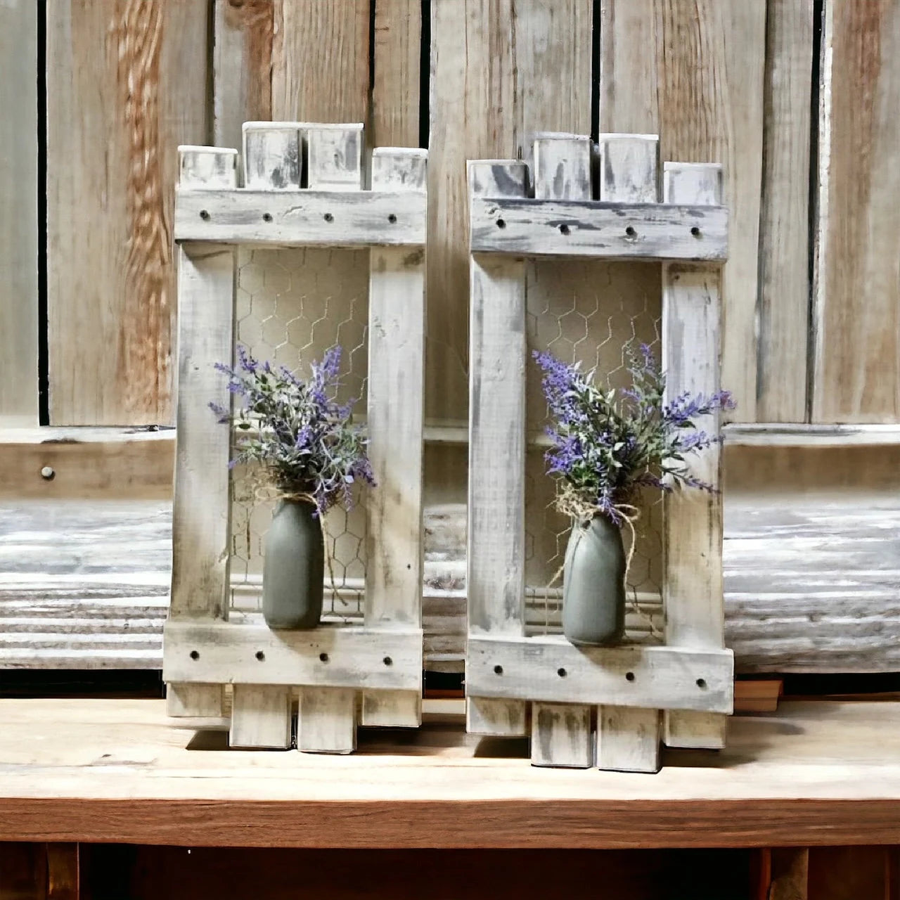 Two wooden candle holders with lavender arrangements on a wooden surface.