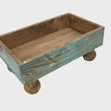 Wooden planter box with a rustic design on a white background