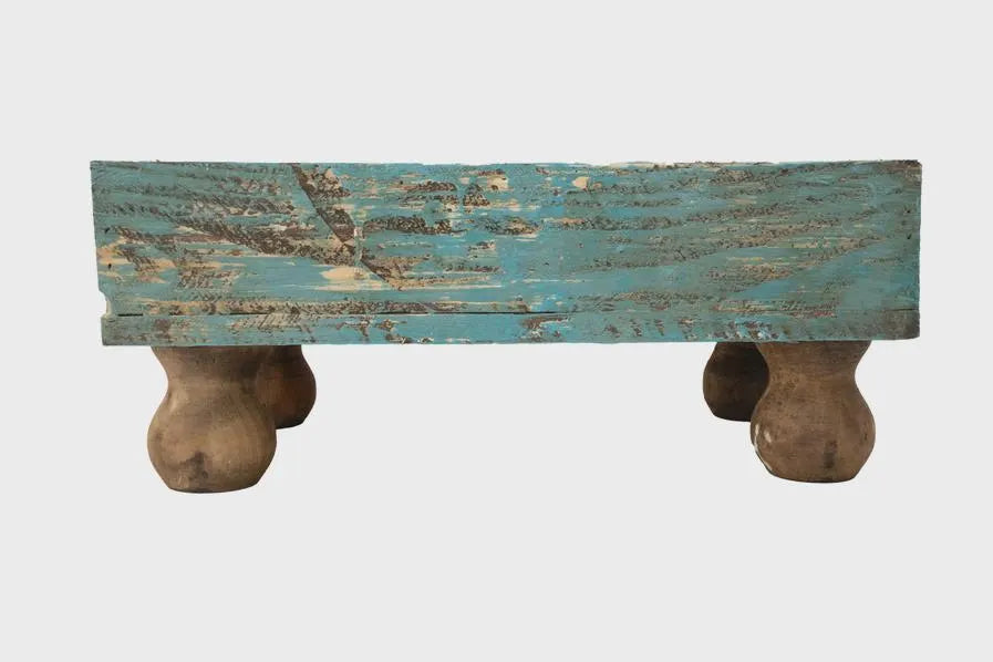 Rustic wooden planter box with a distressed blue top on a white background